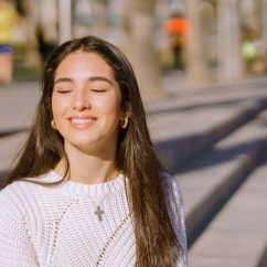 Woman wearing necklace and smiling