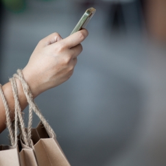 a_person_doing_some_shopping_and_holding_phone.jpg