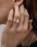 woman_wearing_engagement_ring_and_touching_her_hair.jpg